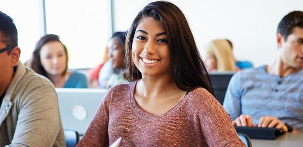 Student Smiling At Desk