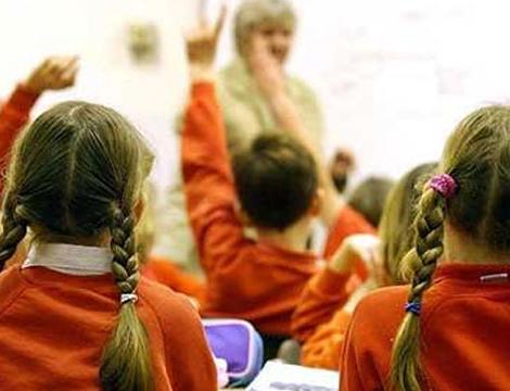 Classroom of students raising their hands