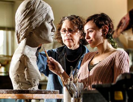CSI PCA students in Art Studio working on a woman's head sculpture