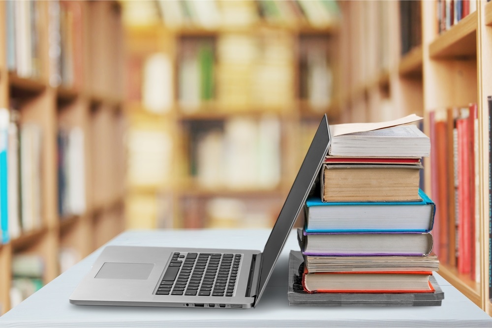 laptop and books in a library