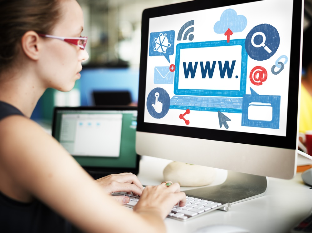 female student looking at monitor for the internet