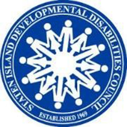 The circular blue-and-white Seal of the Staten Island Developmental Disabilities Council, depicts an inclusive ring of advocates holding hands, surrounded by the organization’s name and founding date of 1969. 