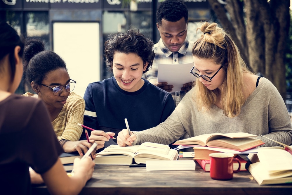 group of students studying around a table