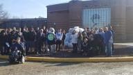 Students with collected 5000 bottles. Group photo in front of 1R building.