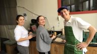 3 students cleaning up the greenhouse