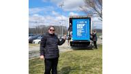 a woman in front of the blue Drop Box Bin
