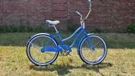 A Cranbrook brand blue - framed cruiser bike with a white and blue seat, white and black wheels, and pedal breaks