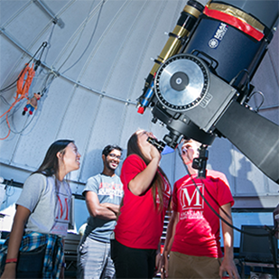 Students looking through telescope