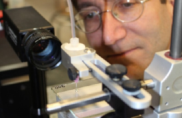 tech incubator man with microscope