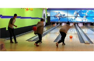Three students bowling