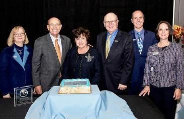 People celebrating the naming of the Lucille and Jay Chazanoff School of Business