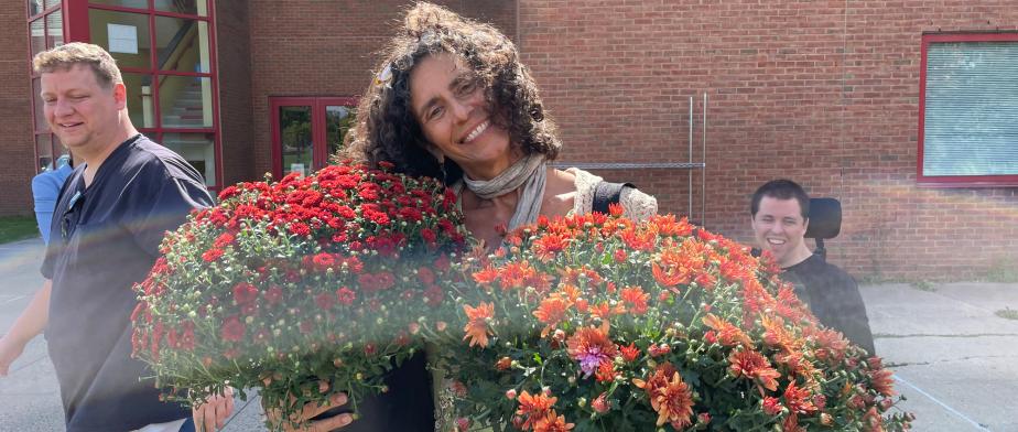 Faculty and Staff with colorful Mums' Planters