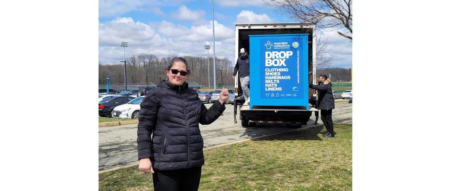 a woman in front of the blue Drop Box Bin