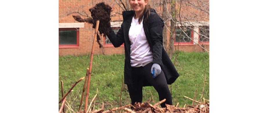 A person holding a shovel with dirt.​