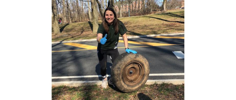 A person holding a tire.