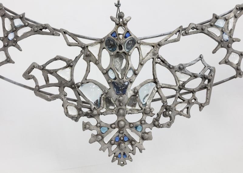 CARNAGE Fall 2024 Art Gallery Detail of a welded steel necklace with embedded blue jewels