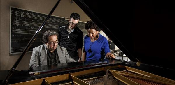 Students and Teacher Sitting At a Piano Playing