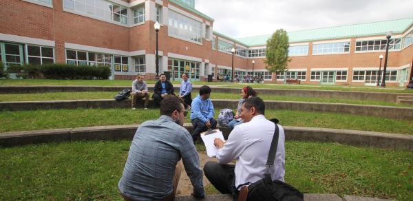 Students Sitting Outside Behind Building 1P