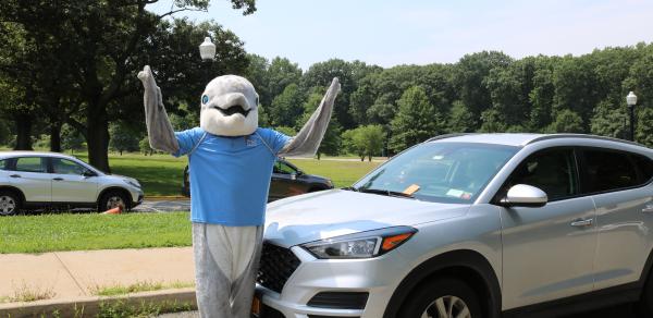 Danny the Dolphin in front of car