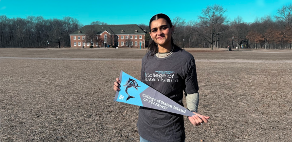 Student Holding A CSI Pennant