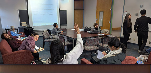 Students Standing And Writing on a Whiteboard