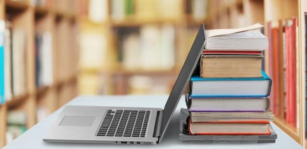 student's computer and books 