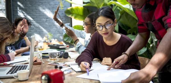 Students Sitting At Wooden Conference Table