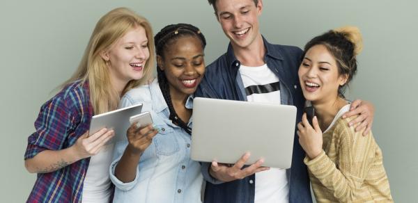 several students looks at laptop screen