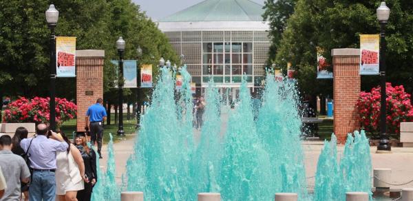 walkway to library with blue water waterfalls