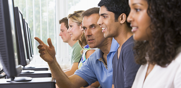 Students sitting at a computer working counseling center