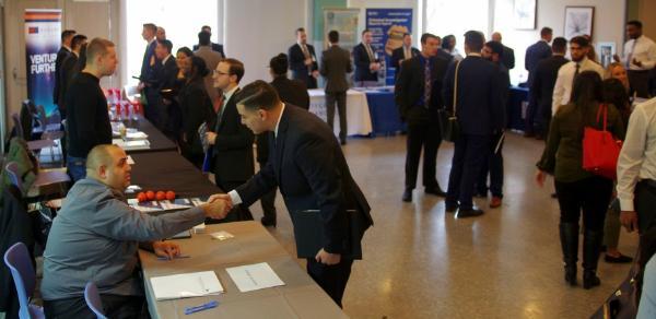 Recruiter and student shaking hands at the annual Accounting Career and Scholarship Fair