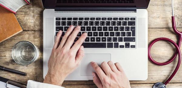 Medical Coding Specialist typing on a keyboard laptot