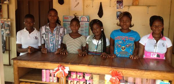 Young girls selling sewing and hair products in a local store, Benin, Africa