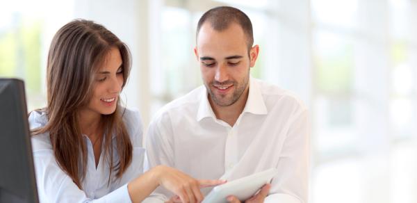 Male and female reviewing papers