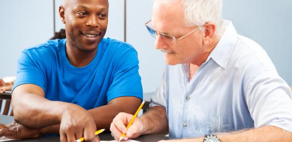 student and teacher at table