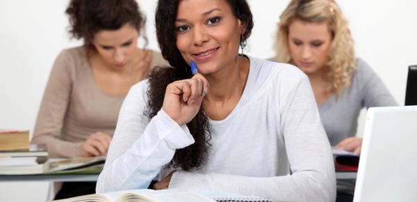 3 women sitting at desk