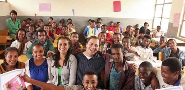 Volunteer in a classroom with students in Africa