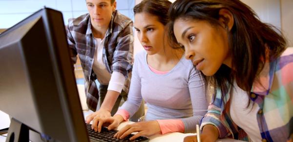 students looking at monitor of PC