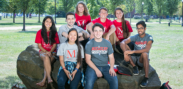 Macaulay Students sitting on a rock