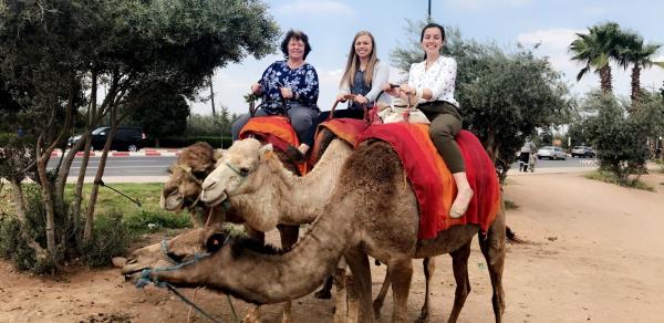 3 women on camels in Morocco