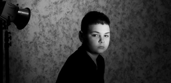 Boy under light in black and white, photo taken by CSI photography student