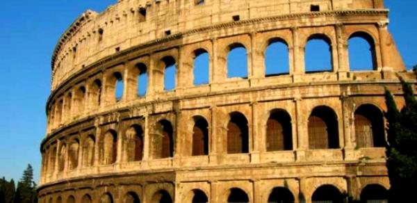 The exterior facade of the Colosseum that consists of four levels, with the bottom three levels composed of arches 