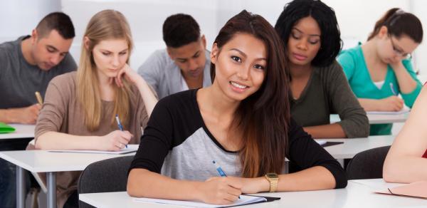 group of female students sitting at desks in classroom