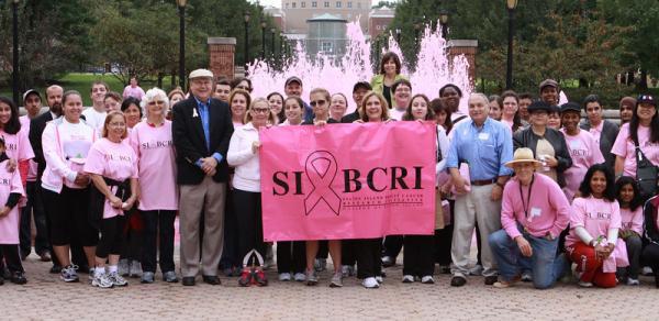 group of people holding SIBCRI banner