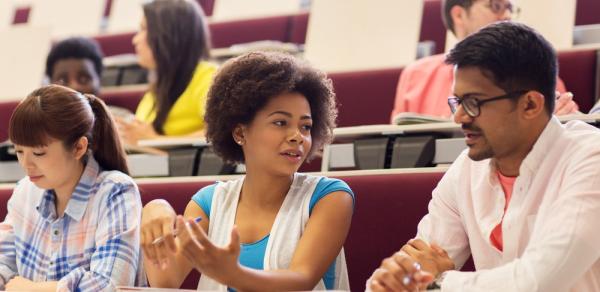 Students In Lecture Hall Taking Notes