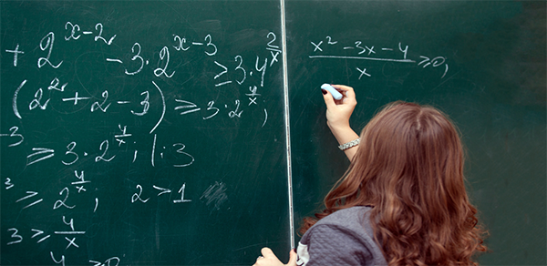 Student Solving Equations on Board