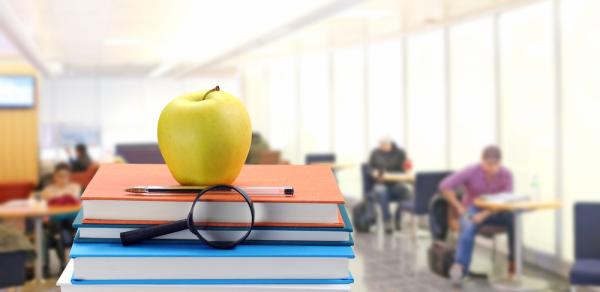 Classroom with Textbooks and Apple