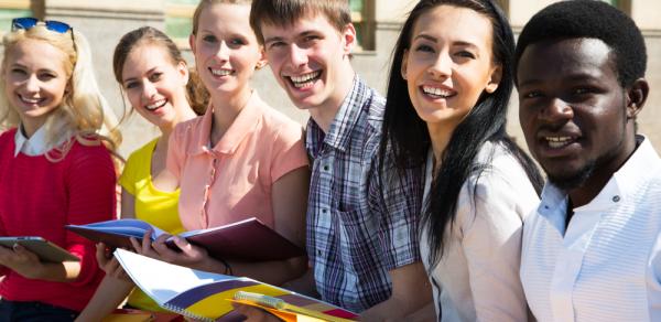 Students Sitting Outside With Books