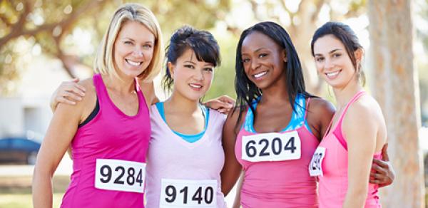 4 women with runner's bibs