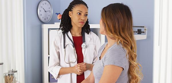 A woman talking to a doctor